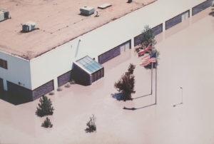 An image of the Mark Andy headquarters in 1993, surrounded by flood water.
